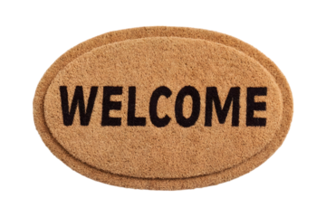 A brown oval doormat with "WELCOME" text, isolated on white.