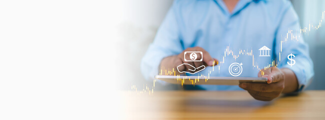 Person in blue shirt using tablet with digital stock market graph, financial icons, symbolizing online investment, digital banking, financial technology, and economic growth on white background.