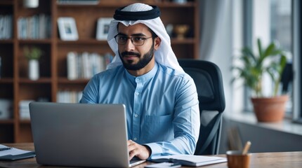 Successfull middle eastern man using laptop at work in bright room. Modern remote work entrepreneur concept