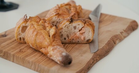 Pieces of bread on a wooden board.