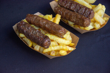 Traditional food from Romania,, grilled meat rolls known as mititei, small ones with fried potatoes
