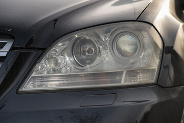 shiny headlights on a gray silver  car
