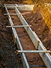 Foundation construction. Wooden forms ready for first layer of concrete to be poured.