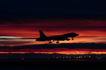 Silhouette of a strategic bomber aircraft taking off against a fiery sunset sky at dusk