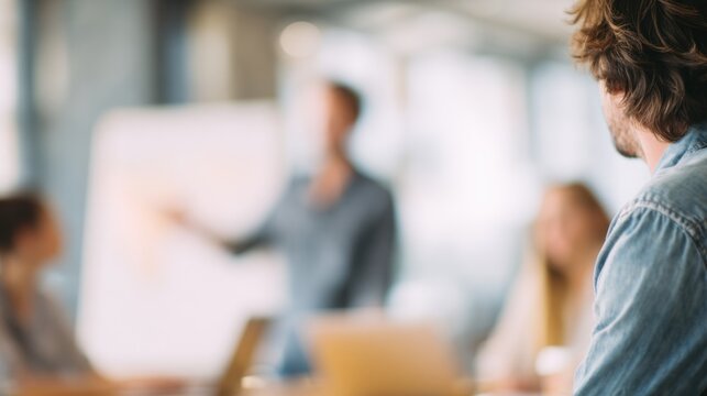 Man in Denim Shirt Observing Meeting - Powered by Adobe