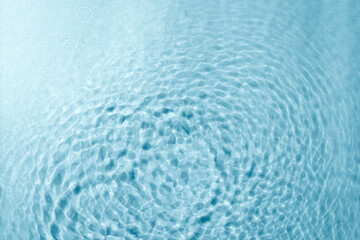 Blue water texture background. Clean transparent water surface with rings and ripples. Summer concept. Flat lay
