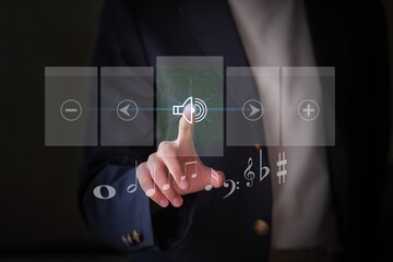 Close-up hand of an Asian businesswoman touching digital screen audio controls.