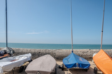 Wissant, Pas-de-Calais, Hauts-de-France, France, July 29th, 2025, Sailboats rest on the sandy beach, creating a serene scene with a calm ocean, warm sun, and blue sky