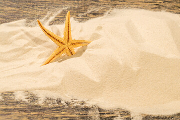 Starfish on the sand with a wooden background. Beach scene. Summer concept © Leo Lintang