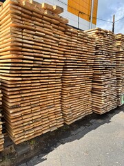 wood sales warehouse. wooden planks are stacked in large blocks for sale.
