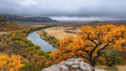 Peaceful autumn valley with golden trees, mistcovered hills, and a crystalclear river meandering through