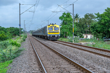 A local suburban commuter train in the countryside  near Pune India.