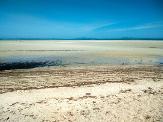 Scenic Sandy Beach with Blue Sky and White Clouds at Nathon Beach, Koh Samui, Thailand