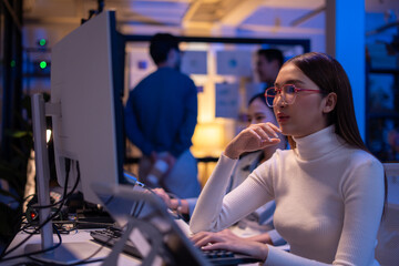 Asian software engineer or programmer team working late in development office,problem solving or...
