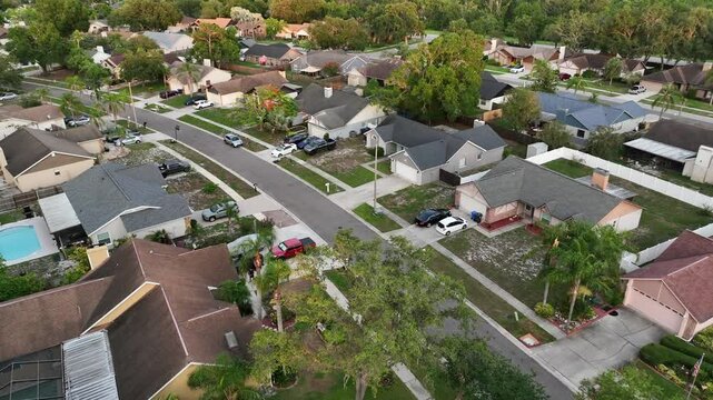 Noble suburb neighborhood with large single family homes, garage and swimming pool in garden. Aerial top down. Suburb district of Brandon, Florida, USA. Wide shot.