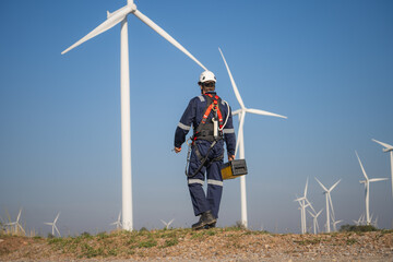 Engineer man working at windmill farm Generating electricity clean energy. Wind turbine farm...