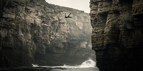 Acrobatic cliff diving into the ocean waters, amidst imposing rock formations