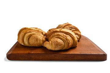 Freshly baked croissants on a wooden tray isolated over a white background