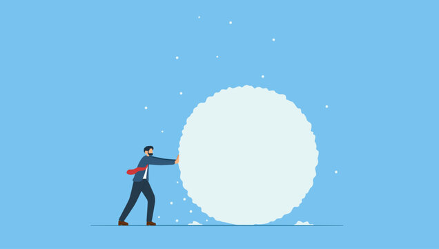 Businessman rolling large snowball build up from small getting bigger. Symbol of snowball effect from small build up larger with potential risk, financial growth or mistake.