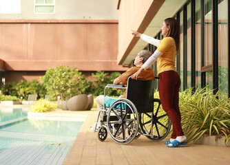Help support retirement health care. A man is being cared for privately at home by an Asian woman...