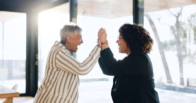Business women, high five and happy at office with success, goals or congratulations for achievement. People, team and mentor with celebration, thanks and promotion by window at insurance agency