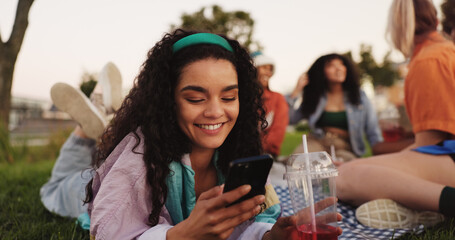 Communication, woman and smartphone on picnic, smile or texting with contact on social media or...