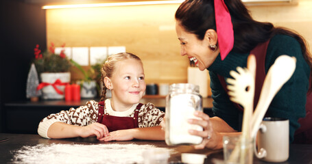 Christmas, baking or flour with mother and daughter in kitchen for December holiday season....