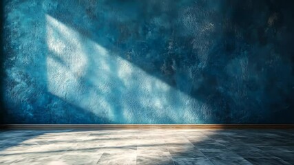 Bright sunlight casts dramatic shadows on a textured blue wall in a serene indoor space