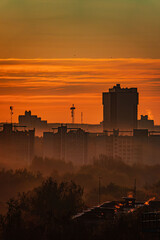 Golden light bathes the city, with skyscraper shadows crafting a stunning dusk skyline