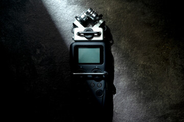 Handy recorder device on a black background. Top view