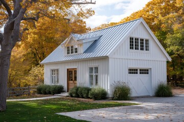 White barn-inspired house framed by autumn trees cool sidelight with soft bloom deep ambient shadows across clapboard siding