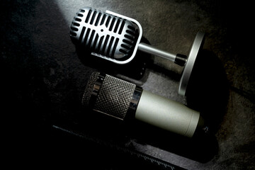 Set of Studio and vintage silver microphones for podcasting or streaming with a black background. Top view
