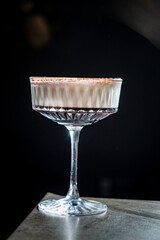 A decadent chocolate dessert served in an elegant glass, capturing attention in low light