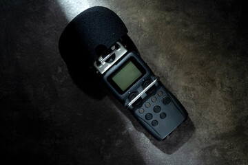 Handy recorder device on a black background. Top view