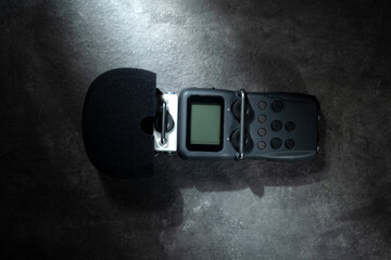 Handy recorder device on a black background. Top view