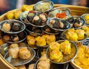Delicate pork shumai, artfully arranged in a small bowl, ready to serve from a traditional bamboo...