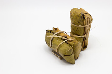 Khao Tom Mat (Thai Sticky Rice with Banana): A traditional Thai dessert made from seasoned sticky rice and coconut milk, filled with banana, and beautifully wrapped in a banana leaf.