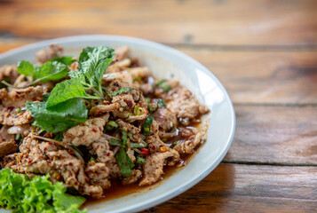 Spicy Thai Larb Moo: Fresh pork salad with a vibrant chili kick, served with refreshing mint. An authentic taste of Thailand