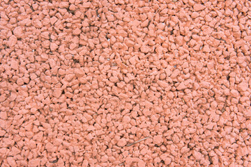 Textura de concreto permeable pintado en color terracota, pavimento poroso pluvial