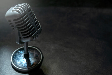 Vintage silver microphone with a black background