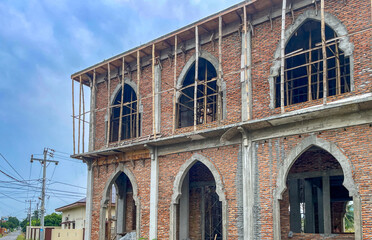 Mosque slowly rises from bricks and bamboo. Though unfinished, the spirit of building Allah’s...