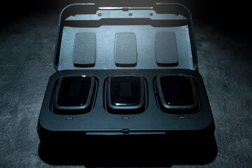 Clip on wireless microphone for interview or podcast equipment in the box on a black background