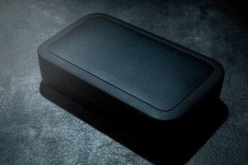 Box of clip on wireless microphone for interview or podcast equipment on a black background