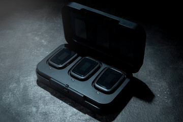 Clip on wireless microphone for interview or podcast equipment in the box on a black background