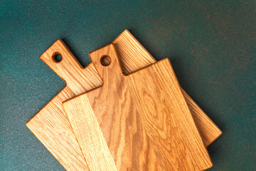 Beautifully crafted wooden cutting boards arranged on a dark surface