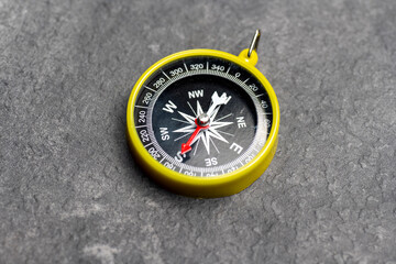 Closeup view of navigational compass on black background. Travel guidance equipment