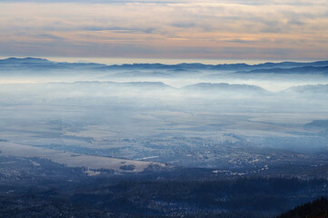 Misty Mountain Valley at Sunrise with Colorful Sky and Rolling Fog