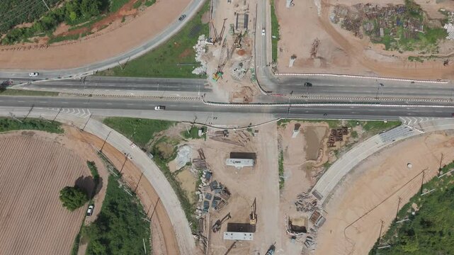 Aerial view drone footage of bridge construction being made across the intersection