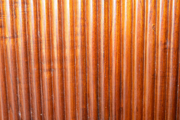 Wooden surface texture with vertical stripes in a warm brown tone, perfect for backgrounds or interior design.