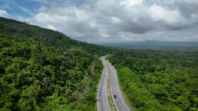 Aerial view of curvy road highway number 304 through dense forest in Thailand
